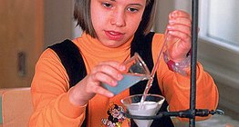 A schoolgirl performing an experiment