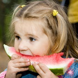 Little girl eating watermelon