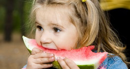 Little girl eating watermelon