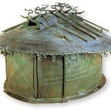 A bronze, house-shaped Etruscan urn