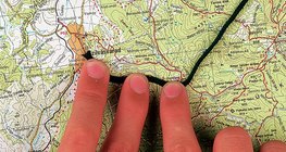 Using a string to determine the distance of a curved line on the map