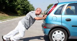 Man pushing a car