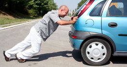 Man pushing a car